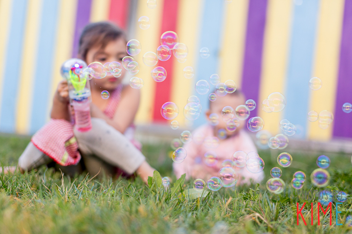 sisters playing with bubble gun