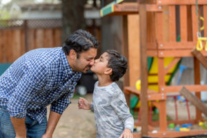 Son kissing dad on nose