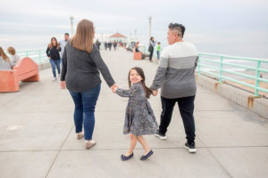 Moms walking daughter on their pier