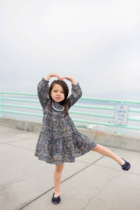 daughter dancing on the pier