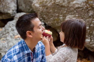 Girl feeding her dad a donut