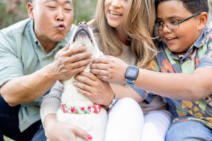 family giving love to their dog for their family pet photos session