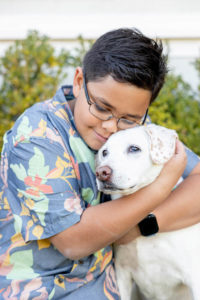 family pet photos with son hugging the family dog