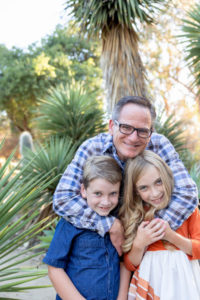 dad hugging his two kids at stanford cactus garden