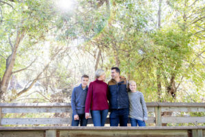 fall portraits at vasona park with family of four on a bridge