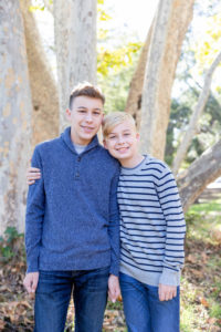 fall portraits at vasona park with two young teen boys hugging each other