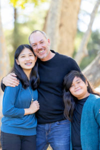 photos at vasona park with dad hugging his two daughters
