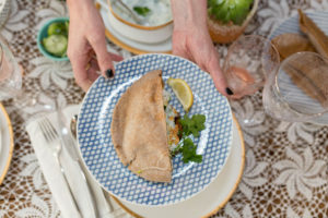 san jose blogger showing a plate of food with a blue plate and pita bread