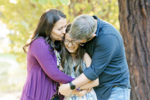 san jose pop up portrait with family of three giving kisses to the girl