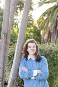 san jose portrait photography session with young man leaning against a tree with his hair down