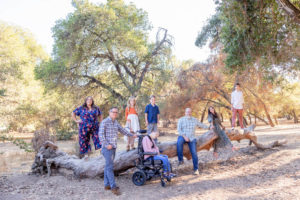 extended family session with eight people on a fallen log at stanford cactus garden