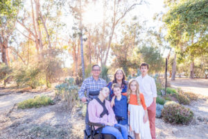 extended family photos with parents, four kids, one in a wheelchair