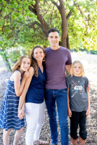 family of four standing at a park for their portrait with family photographer san jose photos by kim e