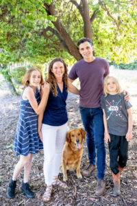 family of four standing at a park with their dog for their portrait with family photographer san jose photos by kim e