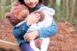 girl holding her teddy bear