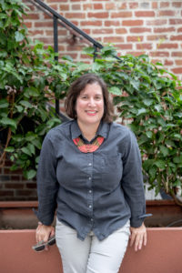 headshot photo of a therapist in downtown san jose next to a brick wall with vines