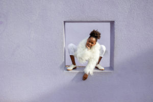 girl standing in a purple wall box while wearing tap dancing shoes