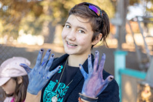 girl showing off her blue hands