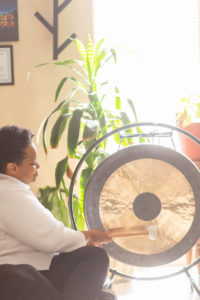 woman hitting a gong