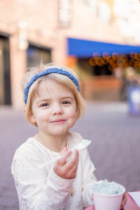 little girl smiling with an ice cream in her hand