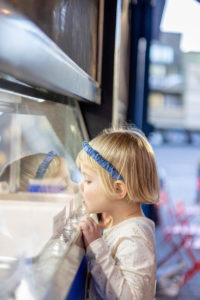 little girl looking at ice cream flavors