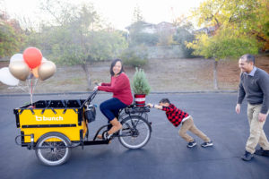 family of three on a bunch bike for their outdoor fall family photos in san jose