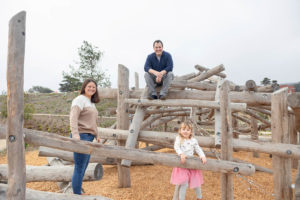 family of three portrait on a wooden play structure at presidio tunnel tops