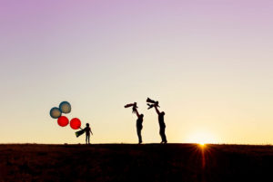 family of five silhouette photography with girl holding balloons