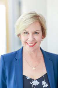 woman wearing a blue jacket for her headshot