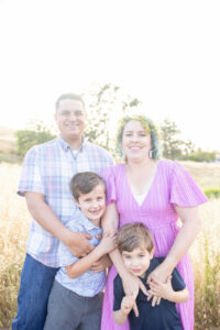 family of four wearing jewel tones for their family photos