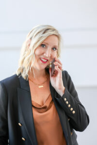 woman talking on the phone wearing gold tones for her business headshot