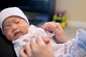 newborn holding her mom's hand