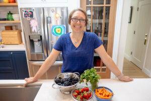 personal trainer and health coach standing in her kitchen for her business branding photography session