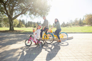 family of three on bicycles at google visitors center