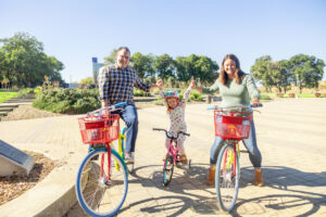 family of three on bicycles at google visitors center