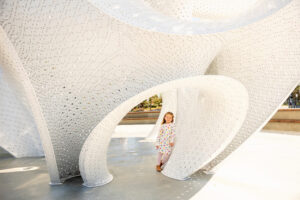 little girl standing under artwork at google visitors center