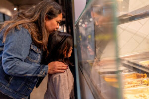 mom and daughter looking at the ice cream choices at downtown los altos penny creamery