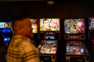 dr no pinball machine in focus with dad in the foreground blurry