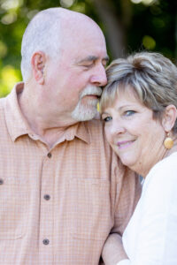 older couple embracing each other at a park for their wedding anniversary photos gift session