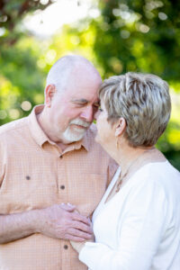 older couple embracing each other at a park for their wedding anniversary photos gift session