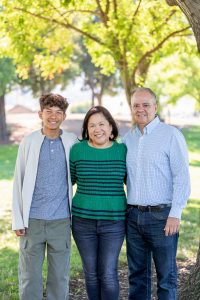family of three posing together
