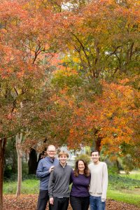 family of four under fall leaves