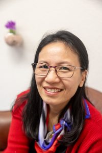 woman wearing red sweater and scarf for headshot