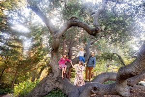 family of four standing in a tree at piedmont park