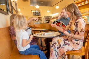 family of four playing uno at a cafe