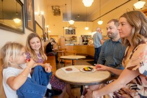 family of four eating at a cafe